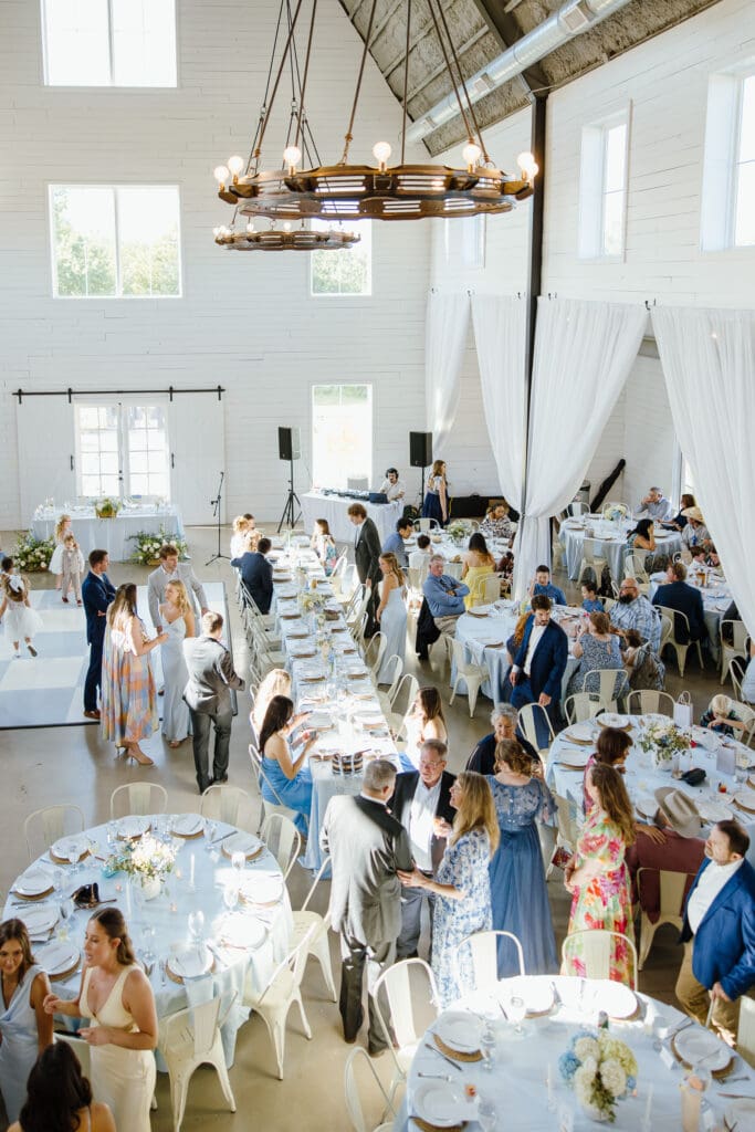 Guests gathering for cocktail hour at The Barn at Paradise Place in Paradise, Texas