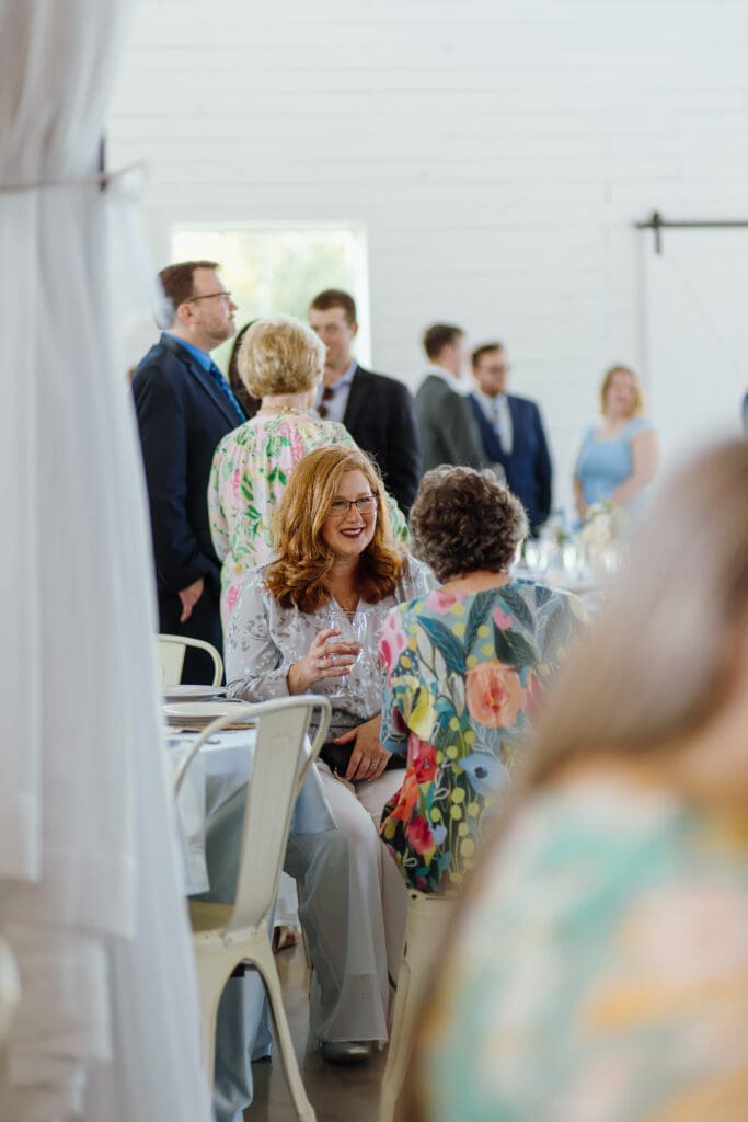 Wedding guests sharing a candid moment during cocktail hour
