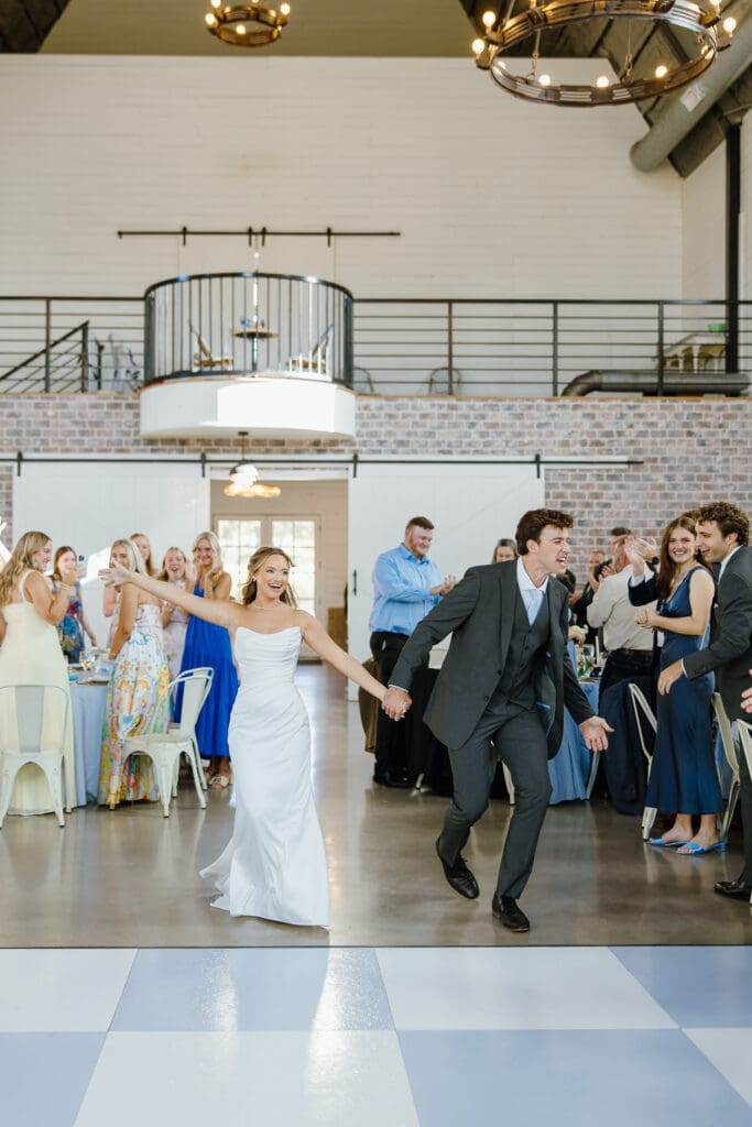 Newlyweds entering their reception at The Barn at Paradise Place