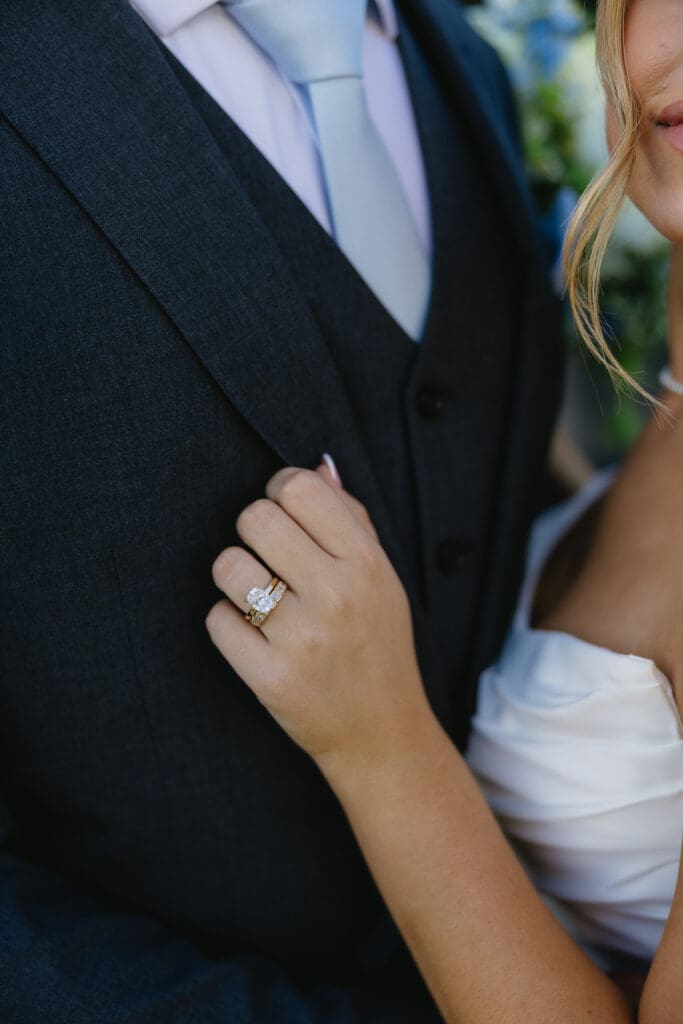 Close-up of the newlyweds with their wedding rings visible