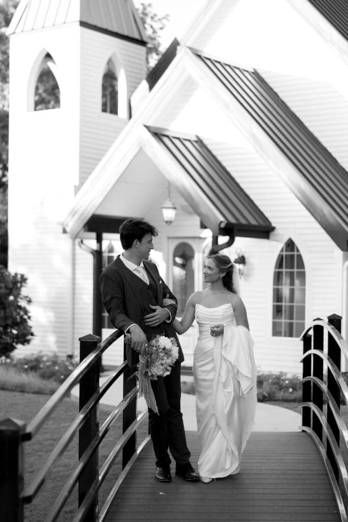 Black and white portrait of the newlyweds outside The Barn at Paradise Place chapel