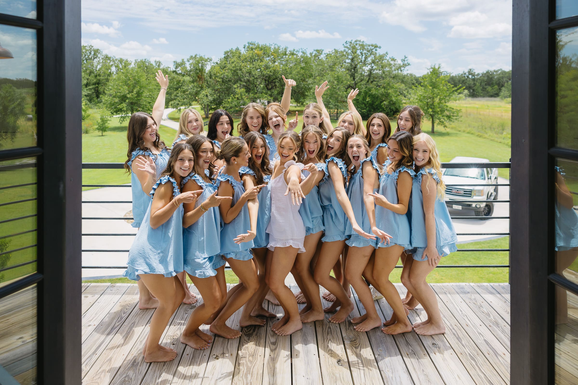 Bridesmaids celebrating together in blue pajamas before the ceremony