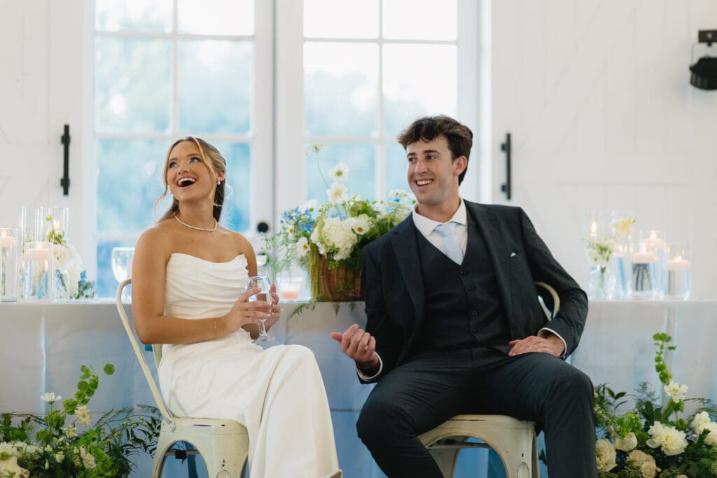 Bride and groom laughing together during their wedding reception