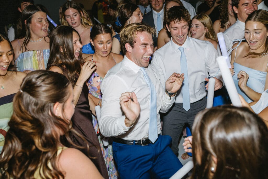 Wedding guests dancing and celebrating during the reception at The Barn at Paradise Place