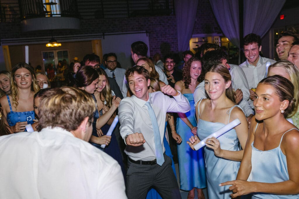 Wedding guests dancing and celebrating during the reception at The Barn at Paradise Place
