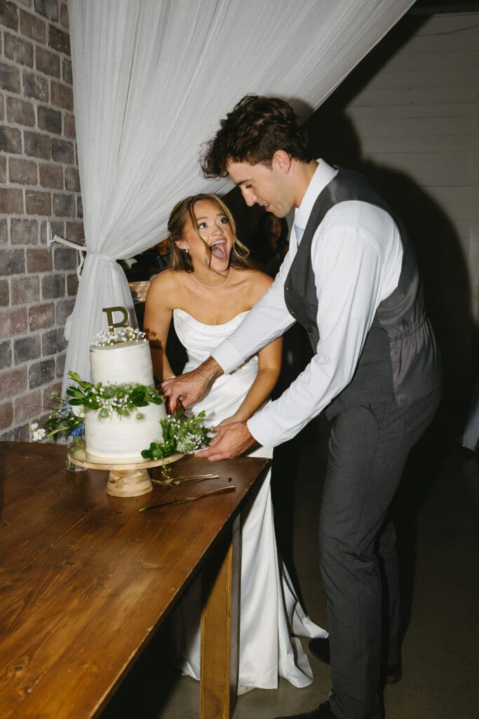 Newlyweds cutting their wedding cake during the reception