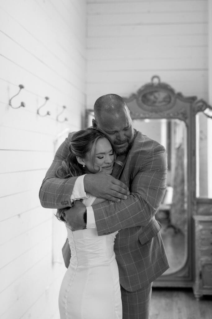Bride hugging her dad during their emotional first look before the ceremony