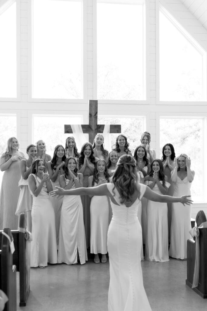 Bridesmaids reacting to the bride during a first look before the ceremony