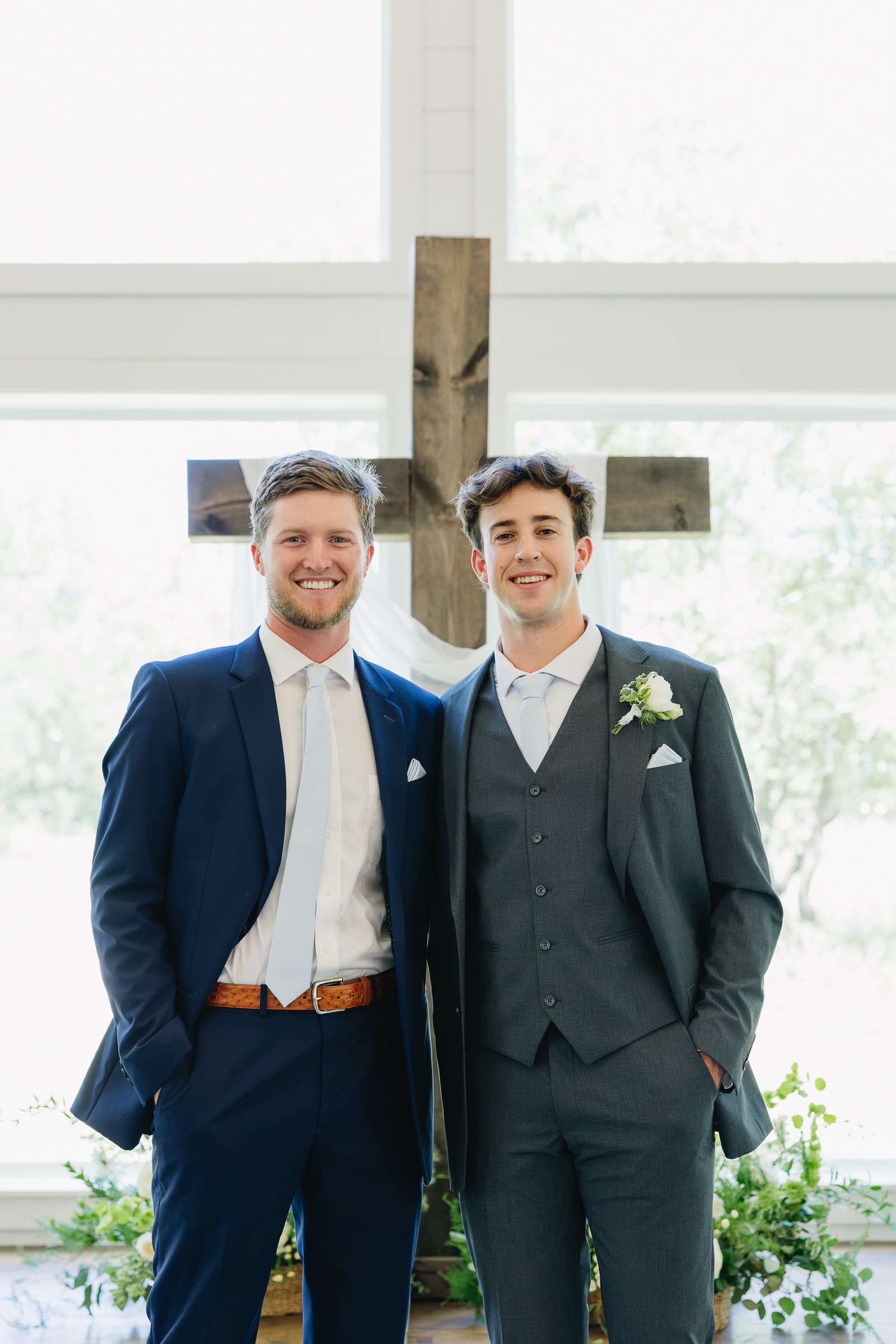 Groom posing with a groomsman before the wedding ceremony