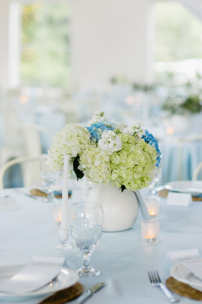 Wedding reception tables decorated with soft blue details and florals