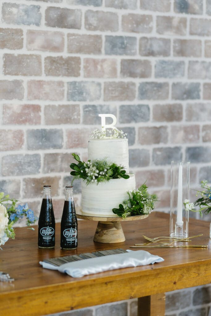Wedding cake displayed on the cake table during the reception at The Barn at Paradise Place