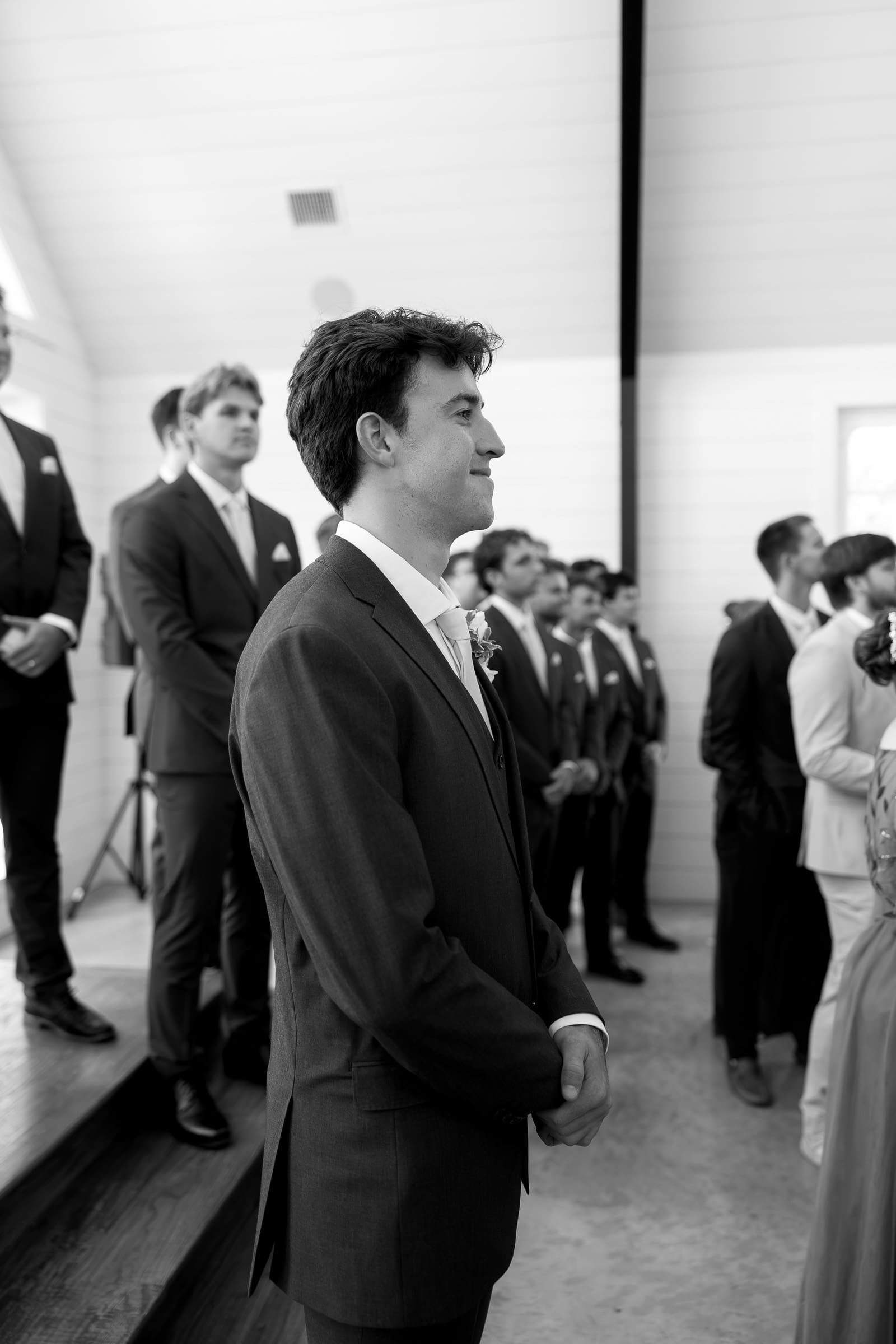 Groom reacting as the bride walks down the aisle during their wedding ceremony