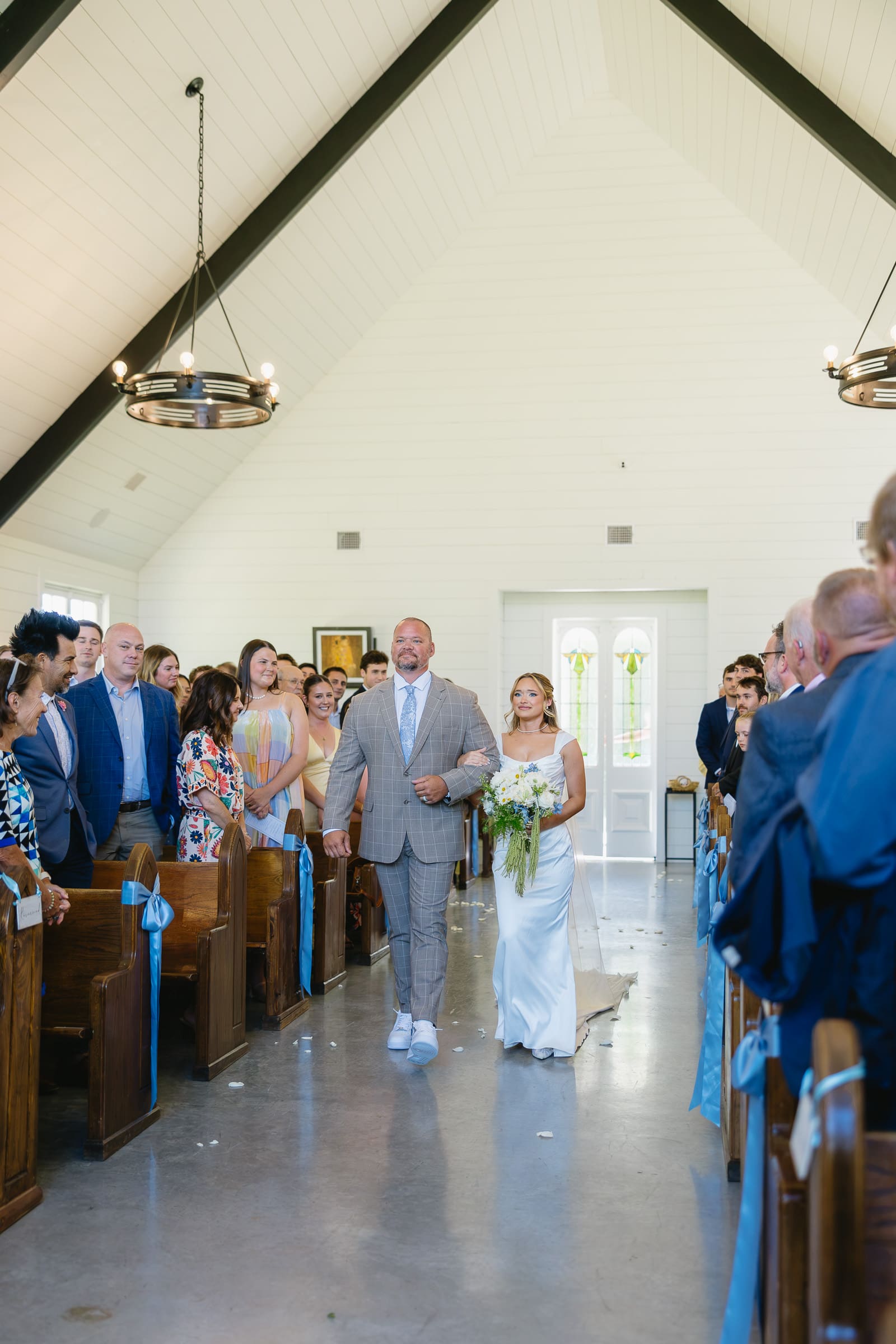 Bride walking down the aisle with her dad at The Barn at Paradise Place