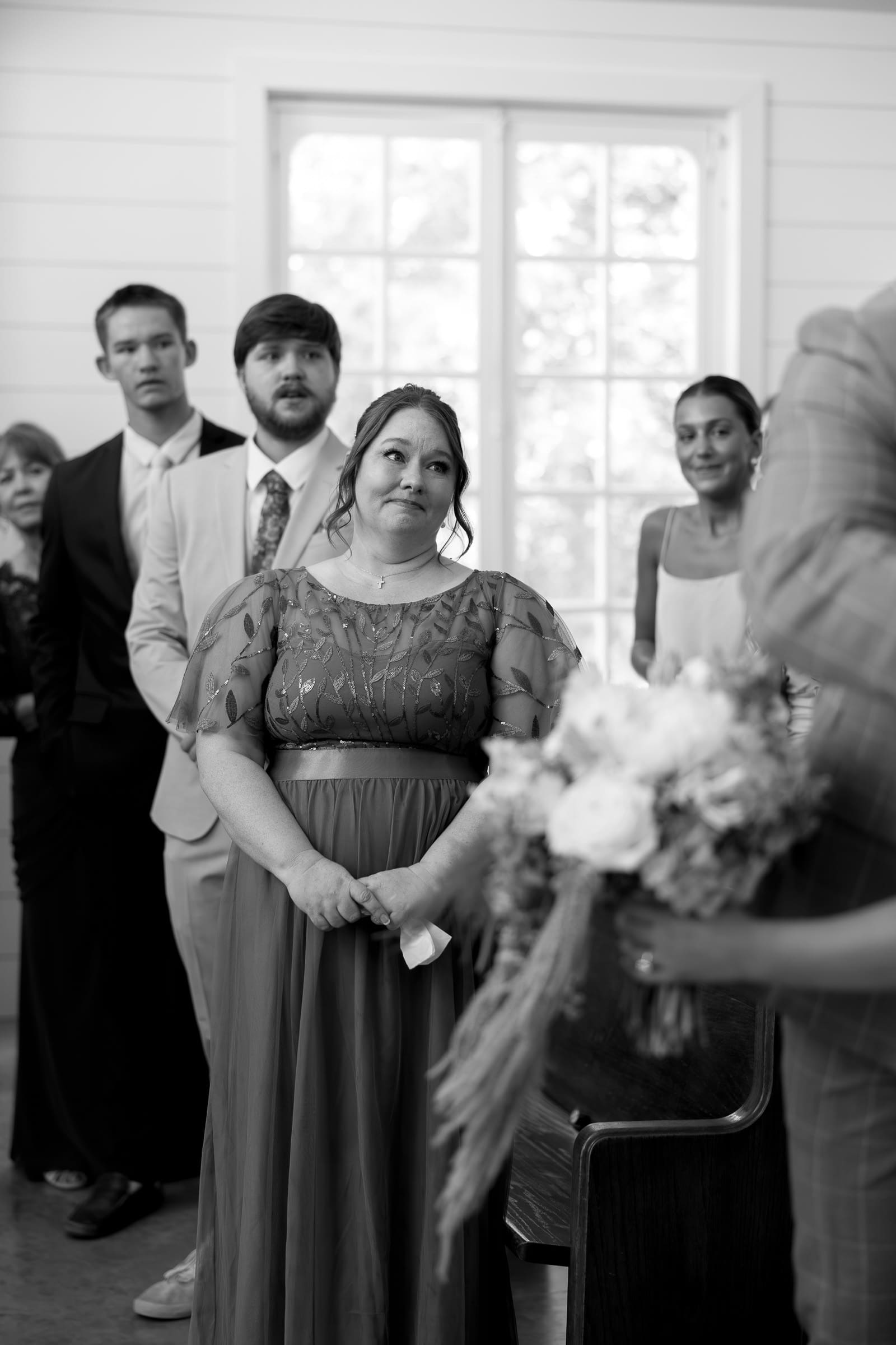 Mother of the bride reacting emotionally during the couple’s ceremony