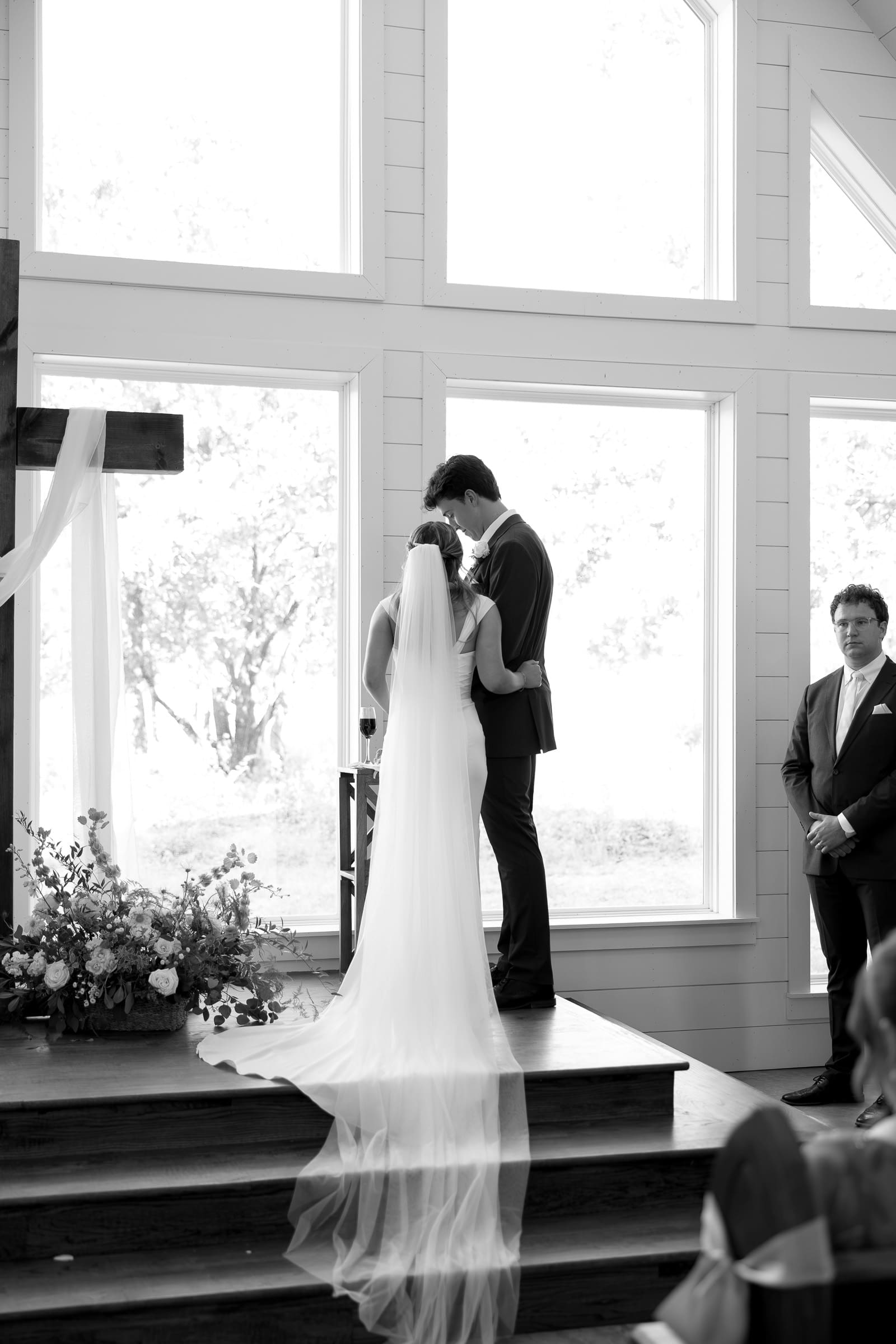 Black and white view of the wedding ceremony inside The Barn at Paradise Place chapel