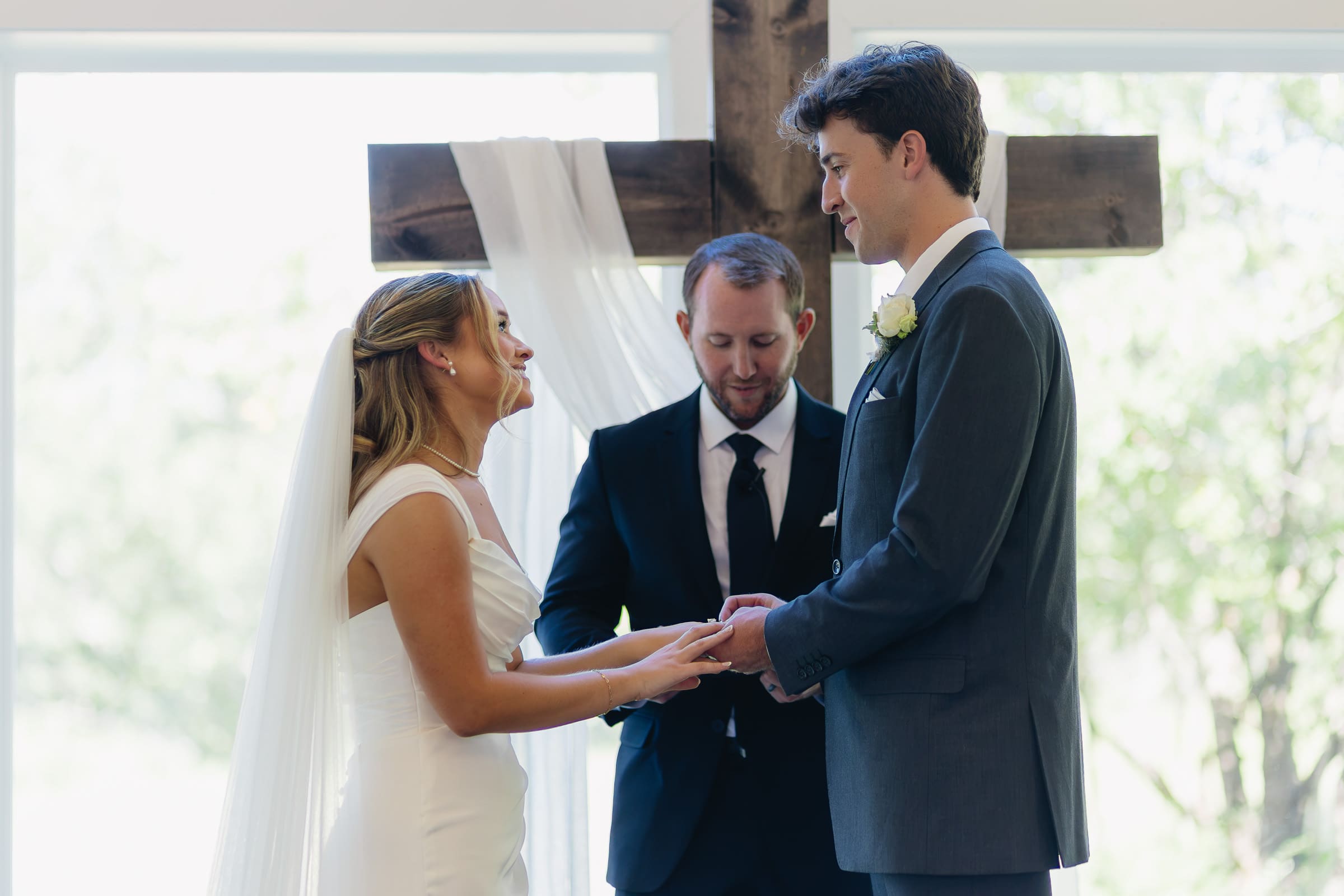 Bride and groom exchanging vows during their chapel wedding ceremony