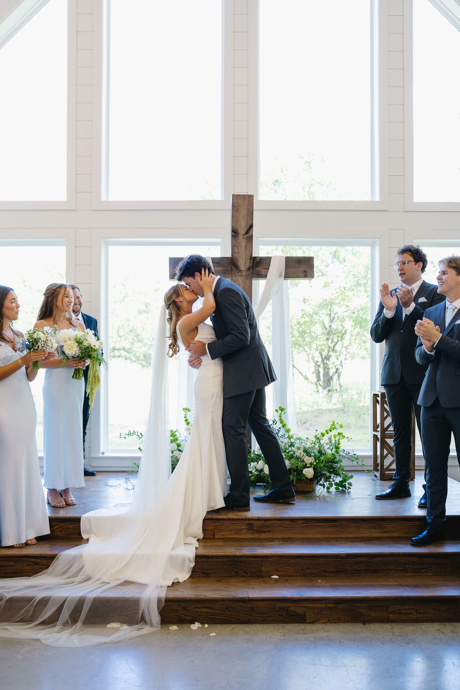 Bride and groom sharing their first kiss during their wedding ceremony