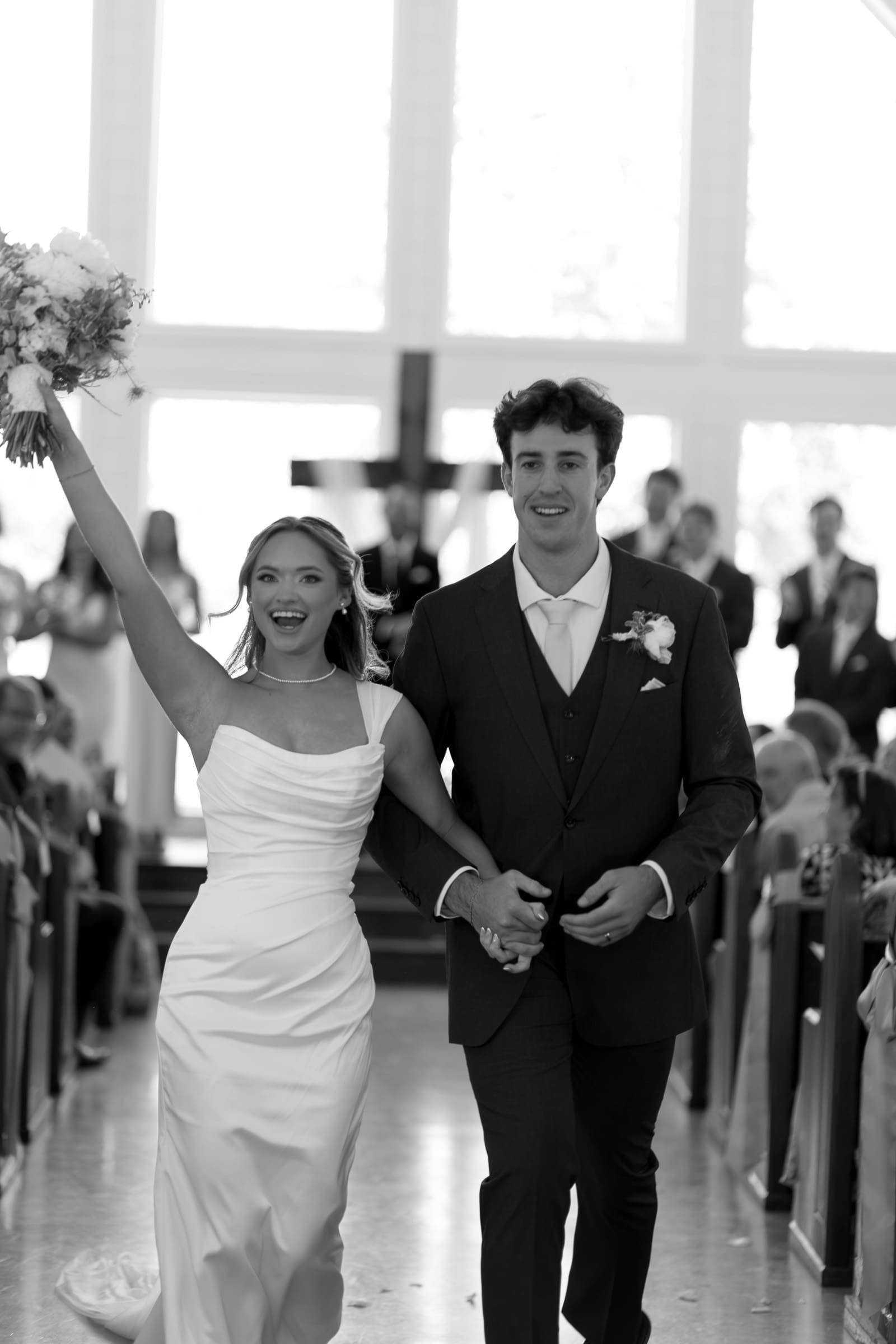 Newlyweds walking back down the aisle together after their wedding ceremony