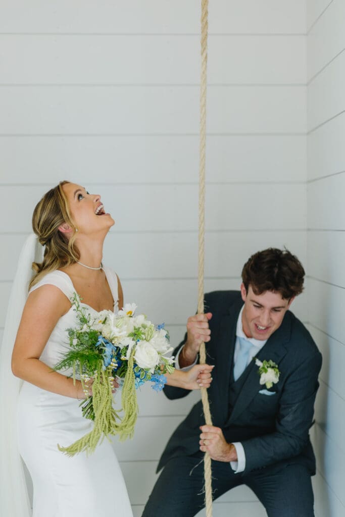 Newlyweds ringing the bell together after their wedding ceremony at The Barn at Paradise Place