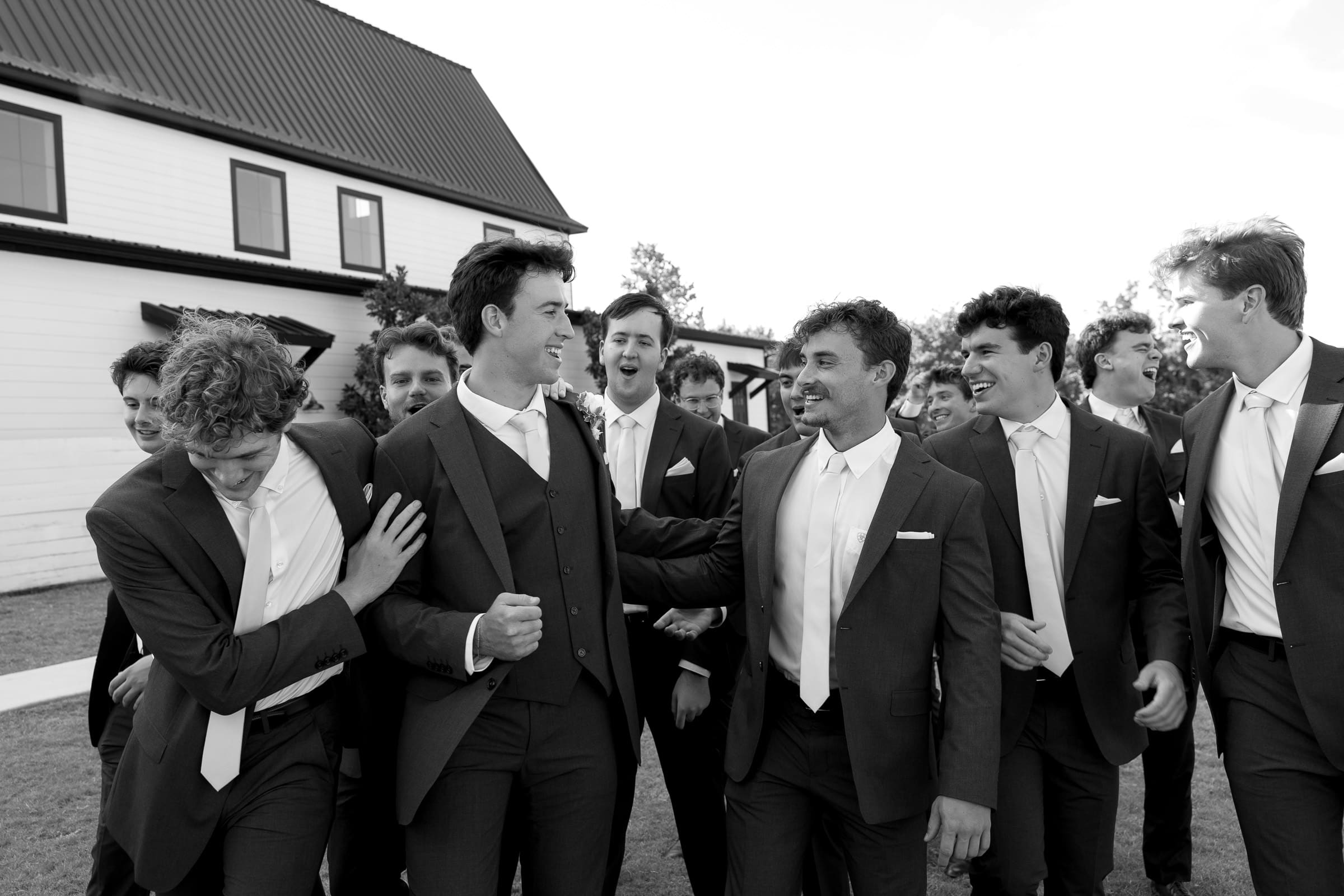 Groom and groomsmen having fun while walking together outside