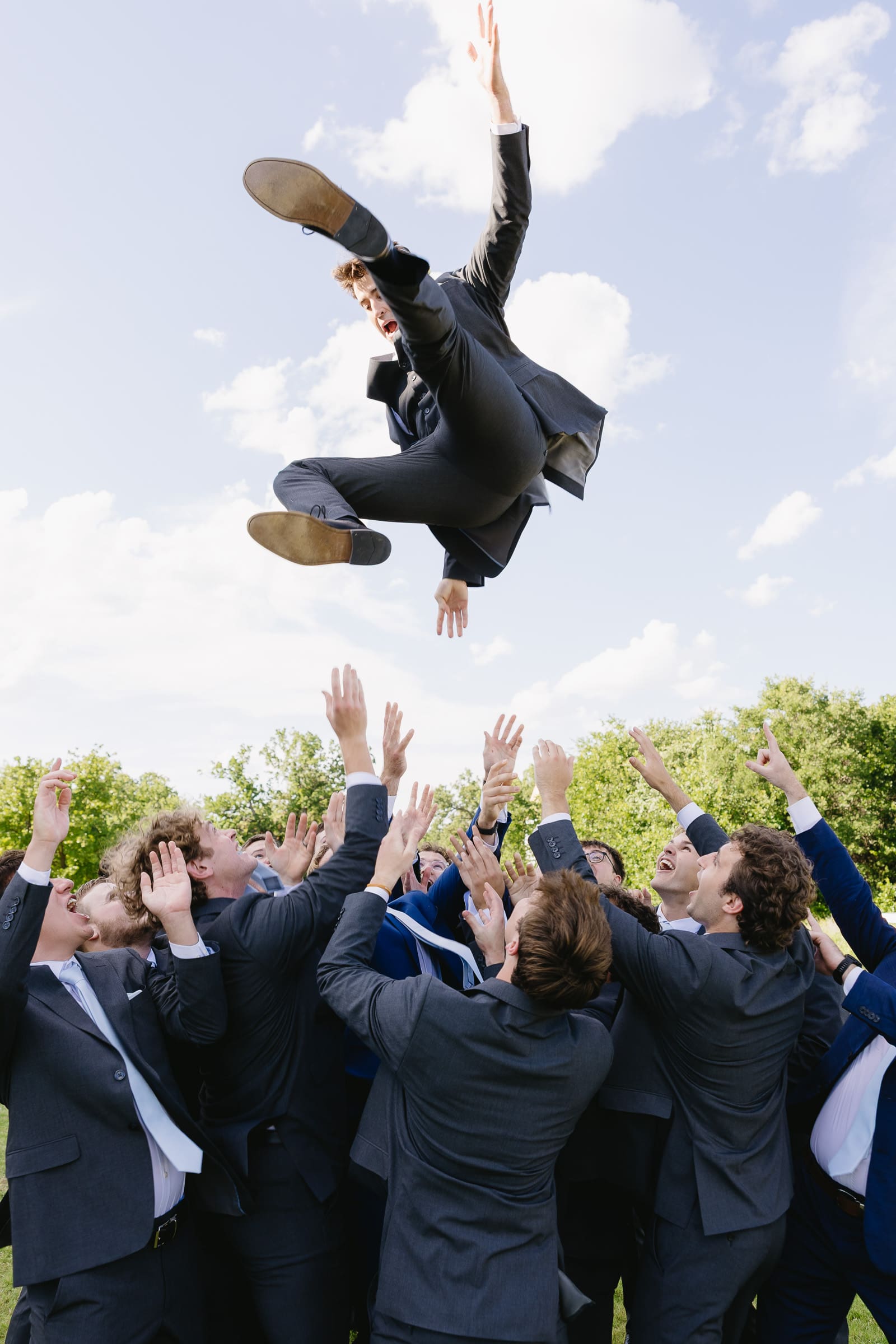 Groomsmen celebrating outdoors at a summer wedding in Paradise, Texas